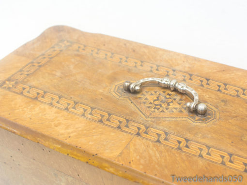 Elegant wooden box with intricate inlay and silver handle, ideal for storage or decoration.