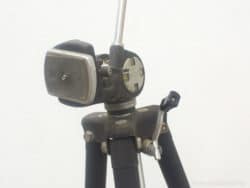 Vintage camera tripod head with durable metal design and adjustable legs for stability.