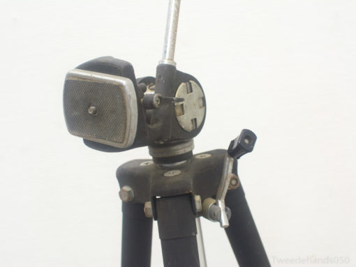 Vintage camera tripod head with durable metal design and adjustable legs for stability.