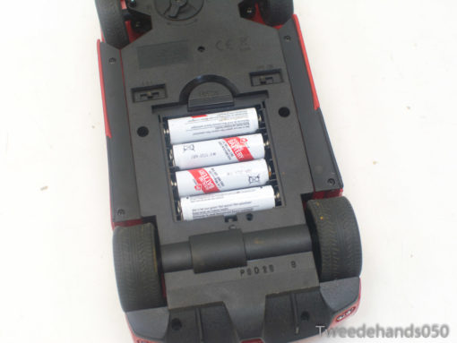 Vintage RC Ferrari toy car featuring an accessible battery compartment for endless fun.