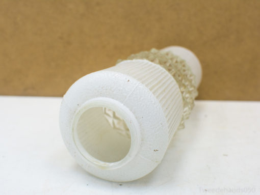 Elegant white vase with ribbed patterns and lace details for stylish floral arrangements.