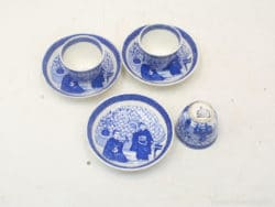 Charming blue and white porcelain tea set with intricate cultural designs, perfect for decor.