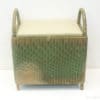 Stylish rattan storage box with cushion and handles for extra seating and organization.