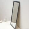 Sleek black mirror enhances minimalist interiors with modern elegance and timeless style.
