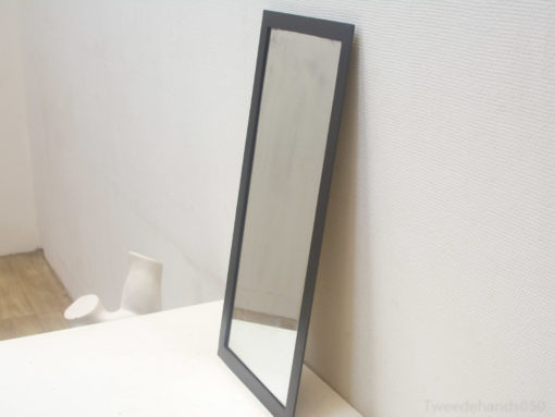 Sleek black mirror enhances minimalist interiors with modern elegance and timeless style.