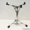 Sleek chrome music stand with adjustable arms for versatile use in performances and rehearsals.