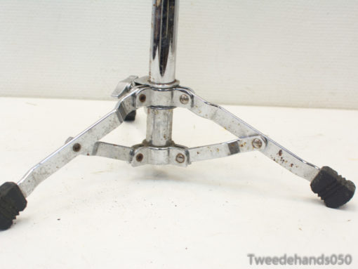 Vintage chrome microphone stand with sturdy tripod design, ideal for musicians and performance settings.
