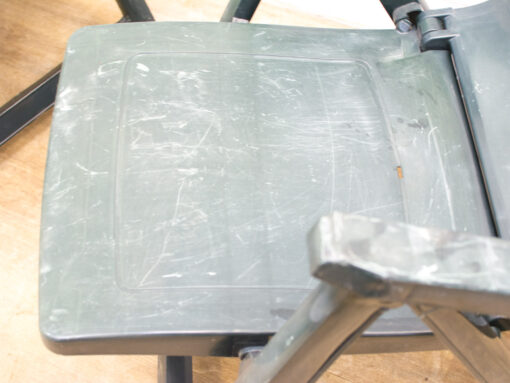 Worn gray chair with character, perfect for functional spaces and inviting environments.