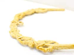 Elegant wooden necklace with intricate floral designs, perfect for a timeless and stylish look.