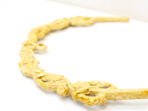 Elegant wooden necklace with intricate floral designs, perfect for a timeless and stylish look.
