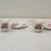 Elegant vintage porcelain tea set with pink floral design, ideal for afternoon tea and decor.