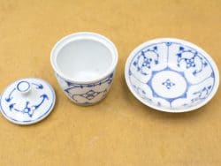 Elegant blue and white porcelain jar and bowl set featuring beautiful floral designs.