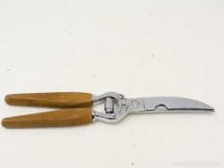 Vintage pruning knife with curved stainless steel blade and ergonomic wooden handles for precise cutting.