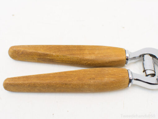 Ergonomic wooden kitchen tools with chrome accents for stylish and efficient cooking tasks.