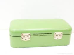 Vintage pastel green storage box with metal clasps, perfect for decor and organizing small items.