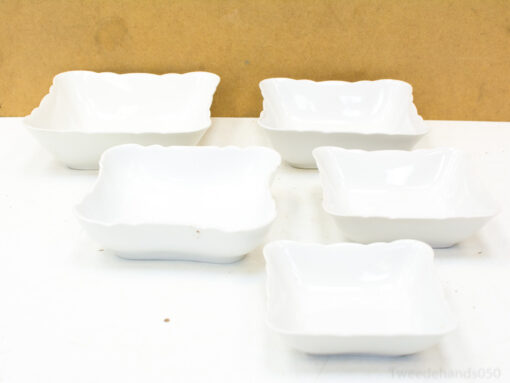 Elegant set of five white serving bowls for versatile dining and stylish décor.