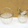 Elegant vintage glass bowl and pitcher set with metal accents for stylish decor and dining.