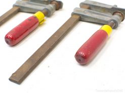 Classic vintage hand clamps with red grips, perfect for woodworking and crafting projects.