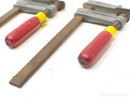 Classic vintage hand clamps with red grips, perfect for woodworking and crafting projects.
