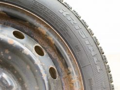 Quality used KRISTALL winter tires on rusted wheels, ideal for safe winter driving.
