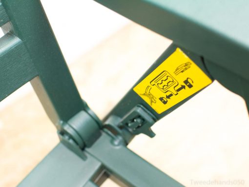Vintage green folding chair with safety features, perfect for stylish outdoor comfort and functionality.