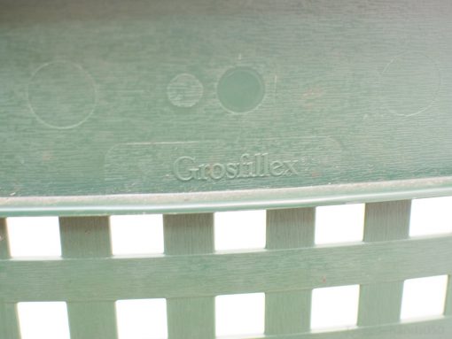 Stylish Grosfillex green outdoor chair, designed for comfort and durability in gardens and patios.