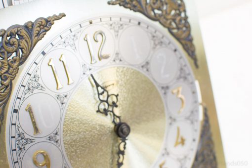 Elegant vintage clock with gold accents and intricate details, perfect for any stylish decor.