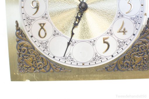Vintage clock with gold accents and floral designs, perfect for classic decor enthusiasts.