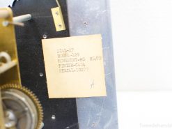 Vintage mechanical clock showcasing detailed golden gears and specifications label, serial number 10279.