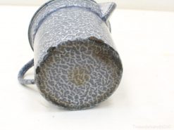 Charming vintage blue speckled mug, perfect for decor or everyday use with rustic appeal.