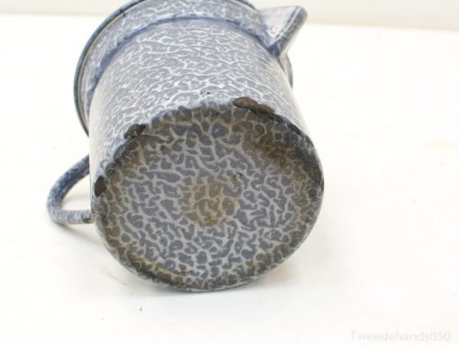 Charming vintage blue speckled mug, perfect for decor or everyday use with rustic appeal.