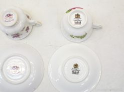 Charming Royal Albert and Paragon teacups featuring elegant floral designs, perfect for tea lovers.