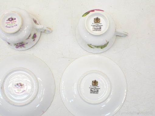 Charming Royal Albert and Paragon teacups featuring elegant floral designs, perfect for tea lovers.