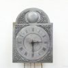 Elegant vintage wall clock with Roman numerals and floral designs, perfect for classic interiors.