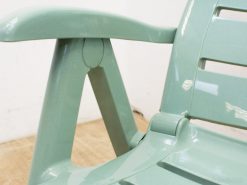 Stylish mint green chair with slatted backrest, perfect for contemporary indoor and outdoor spaces.