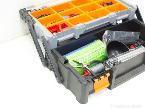 Durable black toolbox with orange compartments for organized tool storage and easy access.