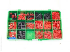 Colorful Fisher Technics toolbox with organized black and red mechanical parts for creative projects.