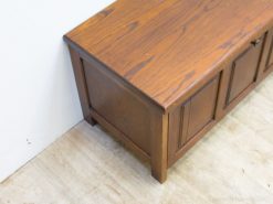 Elegant cherry wood storage bench with panel design, ideal for rustic home decor.
