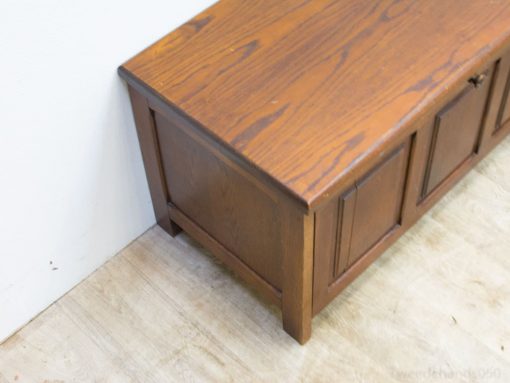 Elegant cherry wood storage bench with panel design, ideal for rustic home decor.