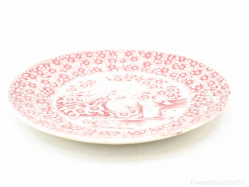 Vintage red and white porcelain plate with floral design, ideal for decor and display.