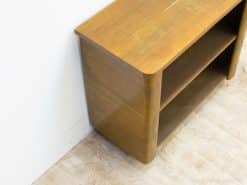 Vintage wooden console with open shelves, combining functionality and warmth for stylish storage.