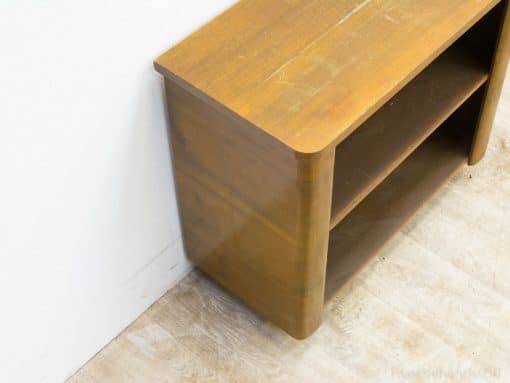 Vintage wooden console with open shelves, combining functionality and warmth for stylish storage.