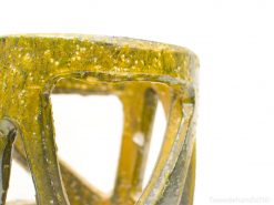 Handcrafted yellow-green translucent sculpture, showcasing organic texture and geometric design, perfect for modern decor.