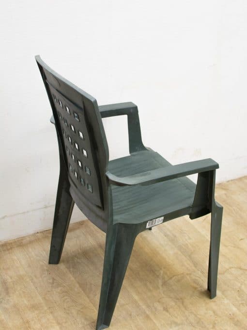 Stylish green plastic chair with ergonomic design, perfect for indoor and outdoor comfort.