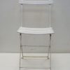 Sleek white folding chair with minimalist design, perfect for versatile indoor and outdoor spaces.