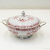 Elegant porcelain tureen with red floral design and gold trim for stylish dining experiences.