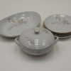 Elegant vintage porcelain dishware set with floral designs, ideal for chic dining experiences.