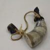 Antique animal horn powder horn with leather straps, showcasing exquisite craftsmanship and historical significance.