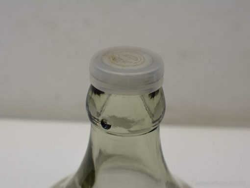 Sleek glass bottle with white cap, ideal for beverages and contemporary home styling.