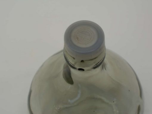 Stylish glass bottle with gray cap, perfect for minimalist decor and beverages.